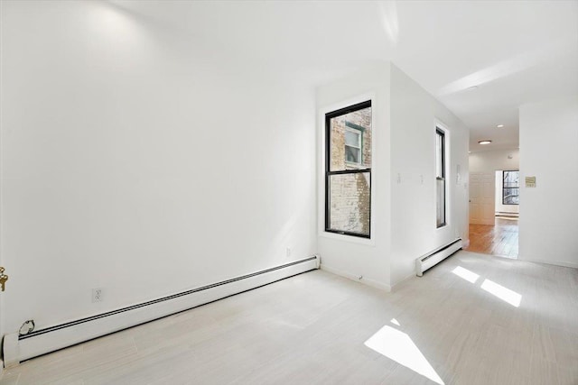 138 Leonard St Unit 2R, Jersey City, NJ 07307 - spare room featuring a baseboard radiator, wood finished floors, and baseboards