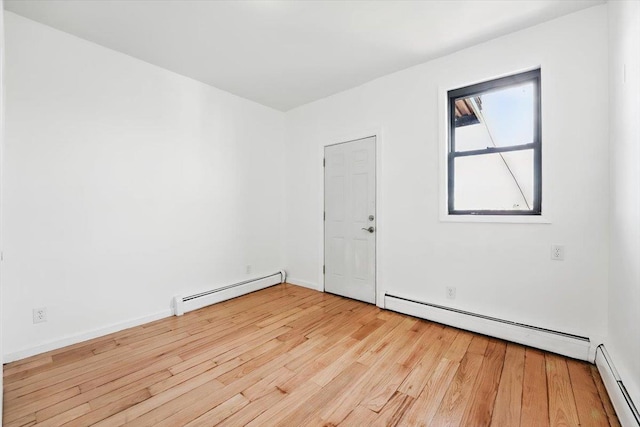 138 Leonard St Unit 2R, Jersey City, NJ 07307 - spare room featuring baseboard heating, light wood-style floors, and baseboards
