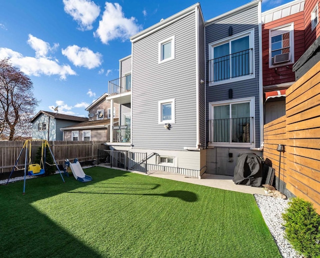 201 Zabriskie St Unit 1, Jersey City, NJ 07307 - rear view of property featuring a playground and a fenced backyard