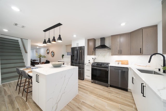 201 Zabriskie St Unit 1, Jersey City, NJ 07307 - kitchen with dishwasher, wall chimney exhaust hood, refrigerator with ice dispenser, gas stove, and a center island