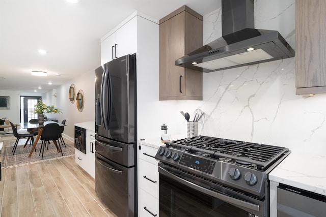 201 Zabriskie St Unit 1, Jersey City, NJ 07307 - kitchen featuring refrigerator with ice dispenser, wall chimney exhaust hood, stainless steel range with gas cooktop, tasteful backsplash, and light stone countertops