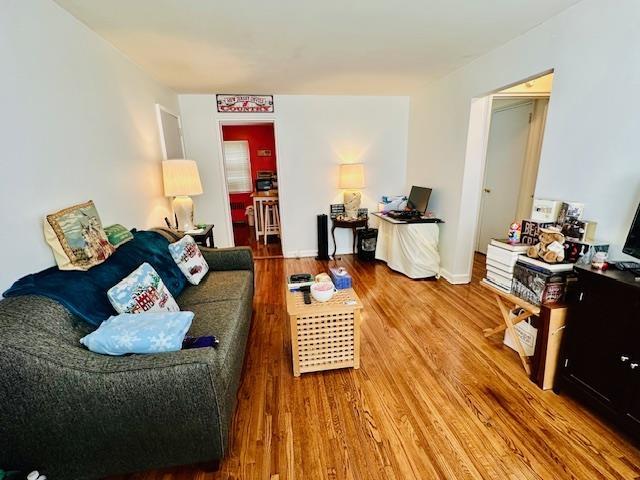 living area with wood finished floors and baseboards