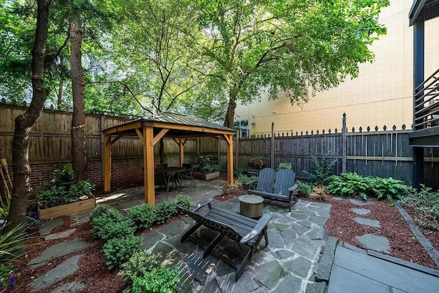 view of patio featuring a gazebo and a fenced backyard