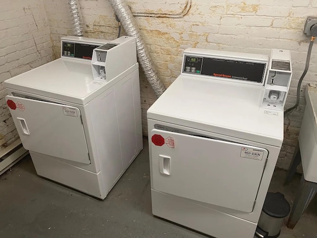 clothes washing area featuring washer and dryer