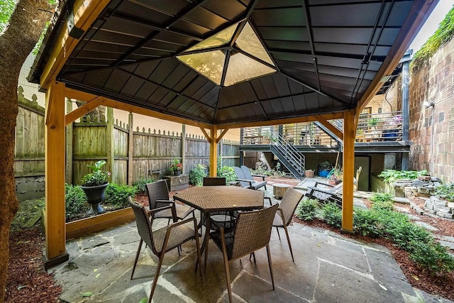 sunroom featuring outdoor dining area and lofted ceiling