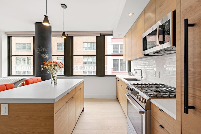 10 Provost St Unit 416, Jersey City, NJ 07302 - kitchen with appliances with stainless steel finishes, light wood-type flooring, backsplash, light countertops, and modern cabinets