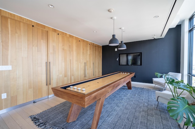 10 Provost St Unit 416, Jersey City, NJ 07302 - recreation room with wood walls, wood finished floors, and an accent wall