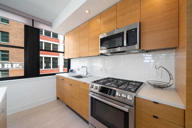 10 Provost St Unit 416, Jersey City, NJ 07302 - kitchen with appliances with stainless steel finishes, backsplash, light wood-style floors, light countertops, and recessed lighting