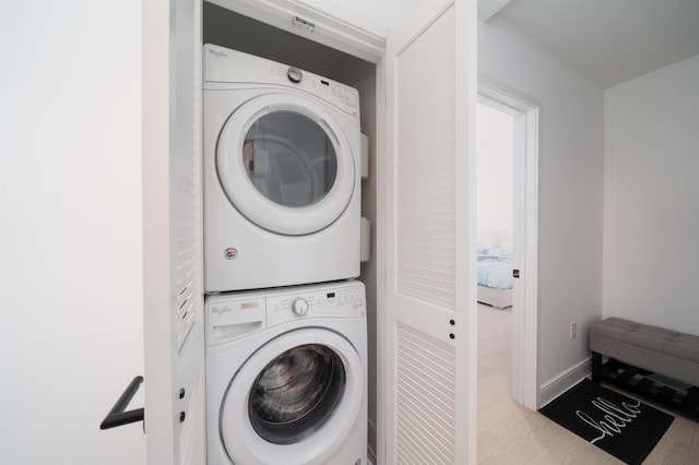 10 Provost St Unit 416, Jersey City, NJ 07302 - washroom with stacked washer / drying machine and wood finished floors