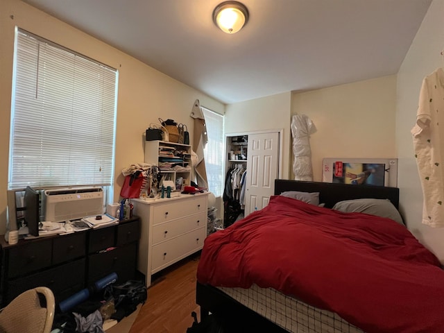 bedroom with a closet and hardwood / wood-style flooring