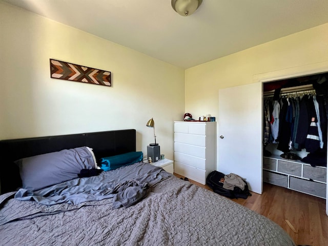 bedroom with a closet and hardwood / wood-style flooring