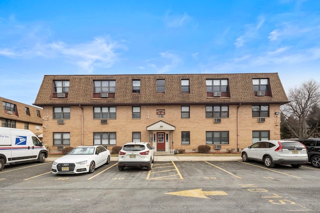 view of building exterior featuring uncovered parking