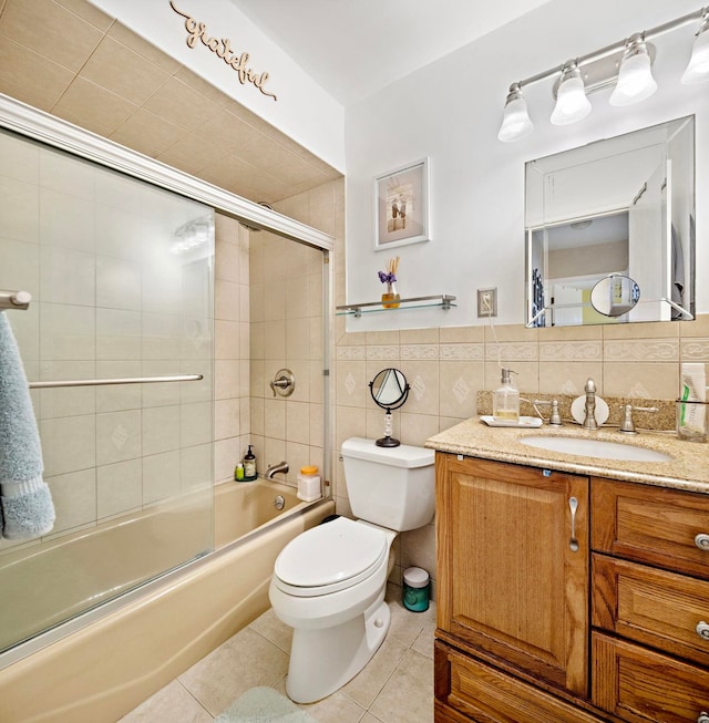 bathroom featuring vanity, tile patterned floors, toilet, and tile walls