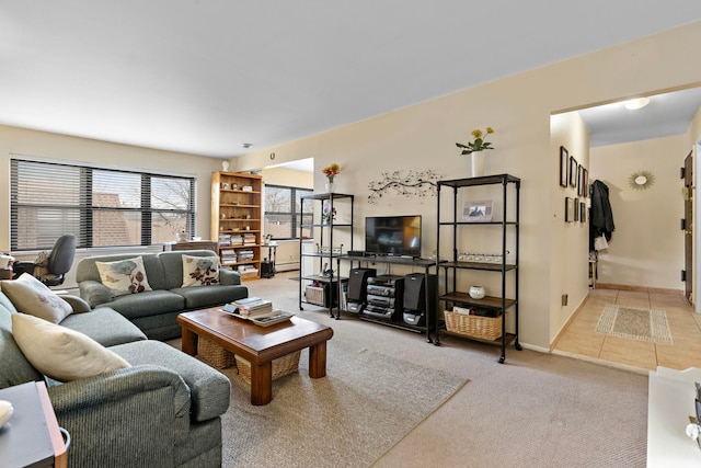 living area with tile patterned flooring, carpet flooring, and baseboards