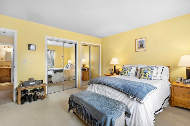 carpeted bedroom featuring two closets