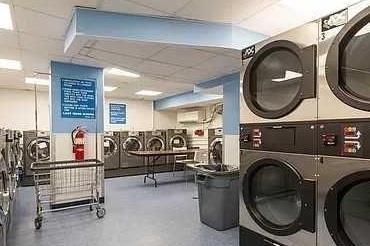 shared laundry area with stacked washer and clothes dryer
