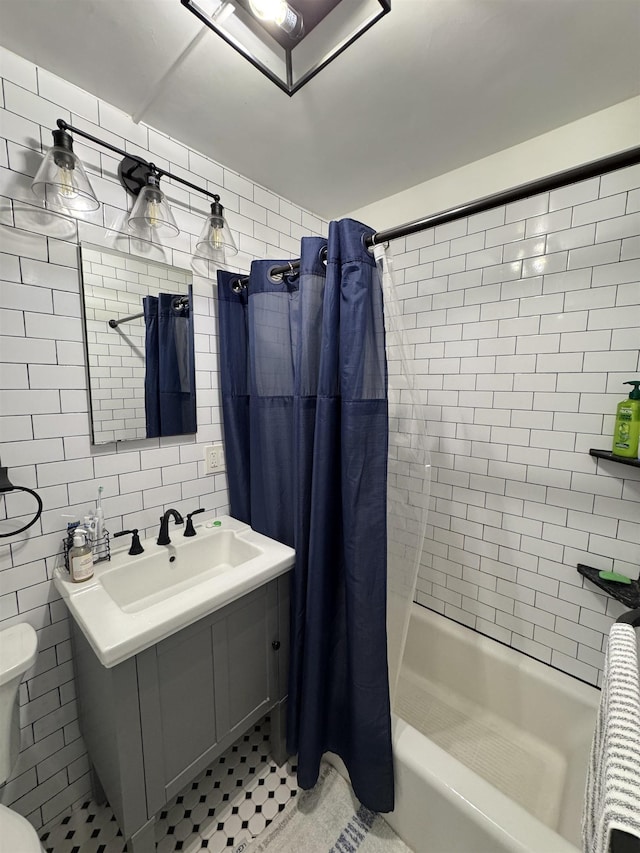 bathroom featuring shower / bath combination with curtain, toilet, tile walls, tasteful backsplash, and a sink