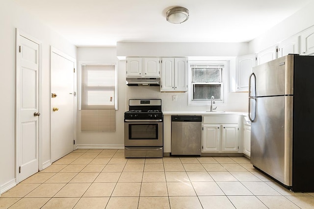 226 57th St, West New York, NJ 07093 - kitchen with stainless steel appliances, under cabinet range hood, white cabinets, and light countertops