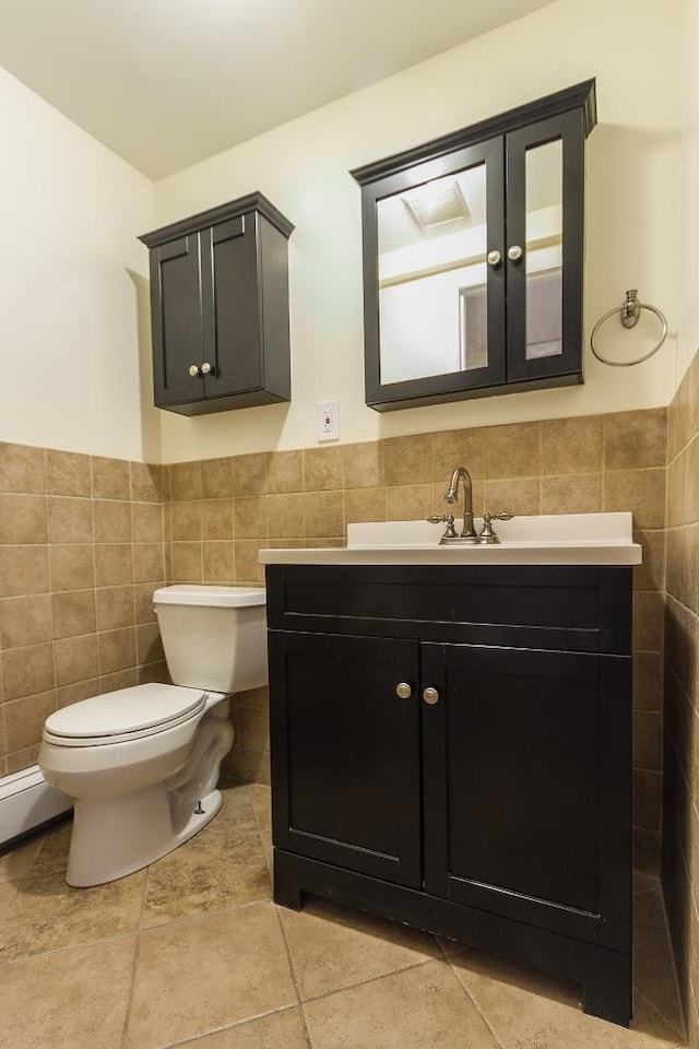 226 57th St, West New York, NJ 07093 - half bath with tile walls, vanity, wainscoting, and tile patterned flooring