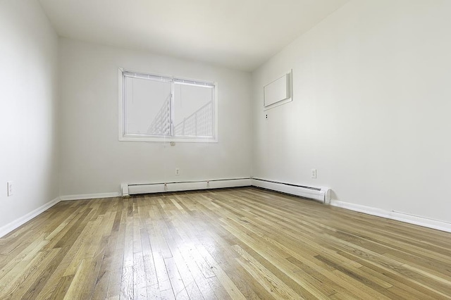 226 57th St, West New York, NJ 07093 - spare room with light wood-type flooring and a baseboard heating unit