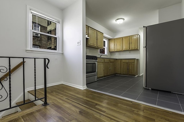226 57th St, West New York, NJ 07093 - kitchen featuring appliances with stainless steel finishes, dark wood-style floors, and brown cabinets