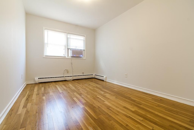 226 57th St, West New York, NJ 07093 - empty room featuring a baseboard radiator, light wood-style flooring, and cooling unit