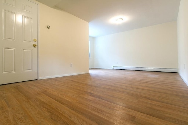 226 57th St, West New York, NJ 07093 - spare room featuring a baseboard heating unit and wood finished floors