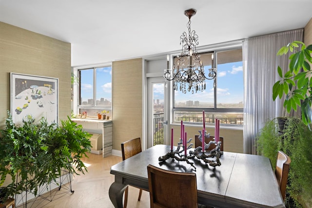 dining area featuring light parquet flooring and a chandelier