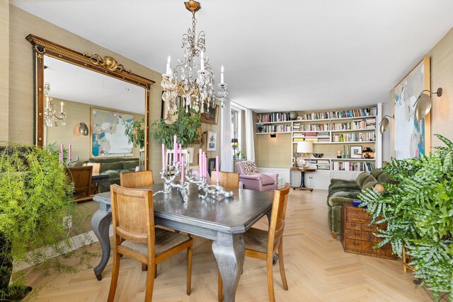 kitchen with sink, gray cabinetry, black electric stovetop, high end refrigerator, and light parquet flooring