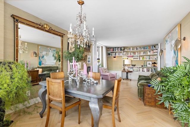 dining space featuring light parquet floors and a chandelier