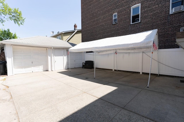 704 90th St, North Bergen, NJ 07047 - view of patio with an outbuilding and fence