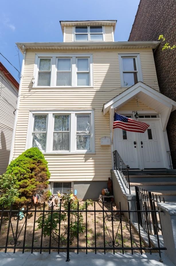 704 90th St, North Bergen, NJ 07047 - american foursquare style home with a fenced front yard