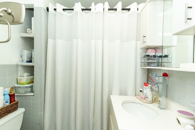 704 90th St, North Bergen, NJ 07047 - bathroom with tile walls, toilet, a shower with curtain, and vanity