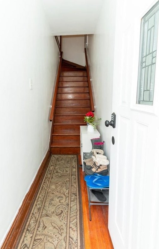 704 90th St, North Bergen, NJ 07047 - staircase featuring wood finished floors