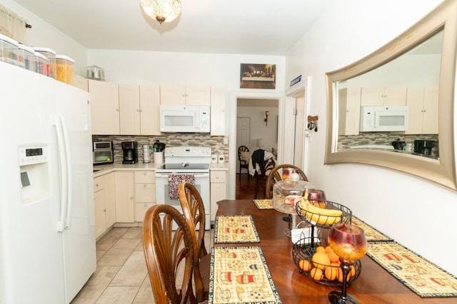 704 90th St, North Bergen, NJ 07047 - kitchen featuring white appliances, tasteful backsplash, light countertops, and light tile patterned floors