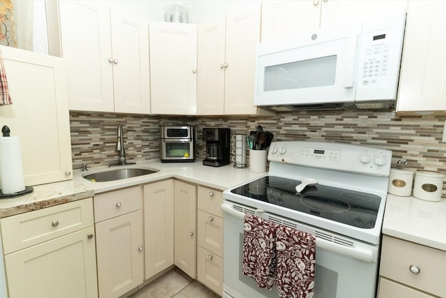 704 90th St, North Bergen, NJ 07047 - kitchen featuring white appliances, a sink, light countertops, and tasteful backsplash