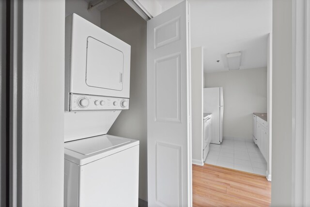 1 2nd St Unit 314, Jersey City, NJ 07302 - laundry room featuring stacked washing machine and dryer and light tile patterned floors