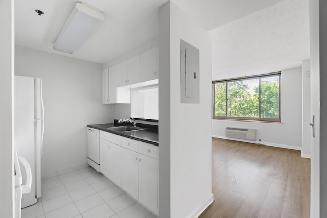 1 2nd St Unit 314, Jersey City, NJ 07302 - kitchen with a sink, dark countertops, electric panel, white appliances, and baseboards