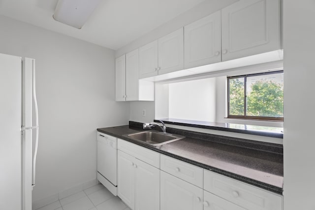 1 2nd St Unit 314, Jersey City, NJ 07302 - kitchen with white appliances, a sink, dark countertops, white cabinets, and light tile patterned floors