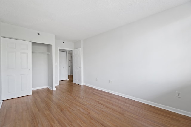 1 2nd St Unit 314, Jersey City, NJ 07302 - unfurnished bedroom featuring light wood-style floors, baseboards, and a closet