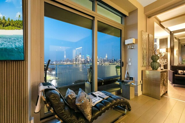 225 River St Unit 1901, Hoboken, NJ 07030 - bedroom featuring wood finished floors, a view of skyline, and access to exterior