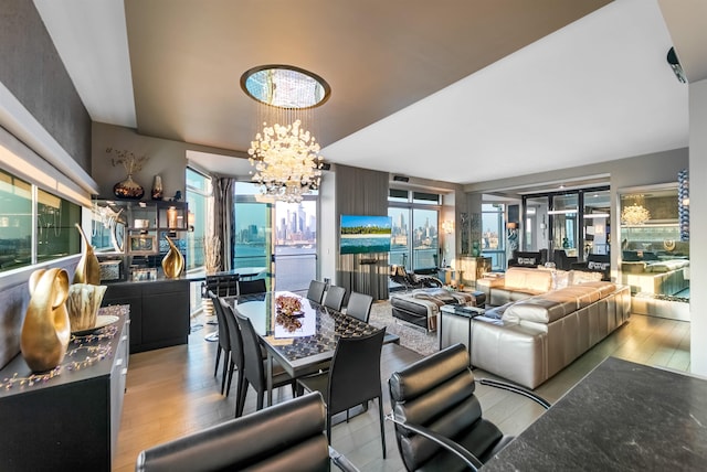 225 River St Unit 1901, Hoboken, NJ 07030 - dining area featuring a chandelier, wood finished floors, and healthy amount of natural light
