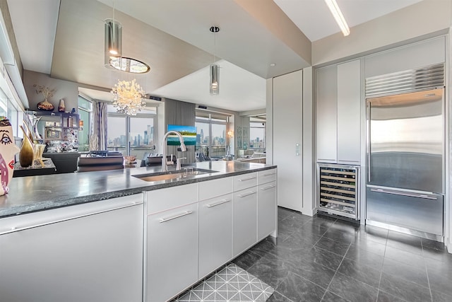 225 River St Unit 1901, Hoboken, NJ 07030 - kitchen featuring built in fridge, beverage cooler, dishwasher, a chandelier, and pendant lighting