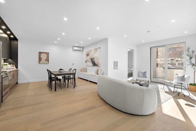 391 1st St Unit 3-B, Jersey City, NJ 07302 - living room with light wood-style flooring, a wall unit AC, and recessed lighting