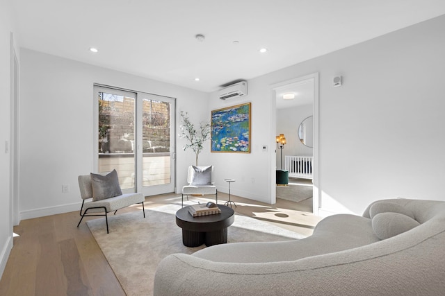 391 1st St Unit 3-B, Jersey City, NJ 07302 - sitting room featuring a wall mounted AC, light wood-type flooring, recessed lighting, and radiator heating unit
