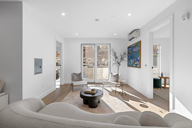 391 1st St Unit 3-B, Jersey City, NJ 07302 - living area featuring a wall unit AC, electric panel, wood finished floors, and recessed lighting