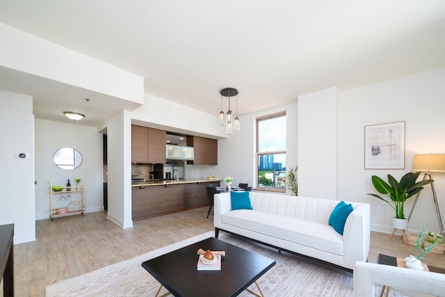 10 Regent St Unit 807, Jersey City, NJ 07302 - living room featuring plenty of natural light, light wood-style flooring, and a chandelier
