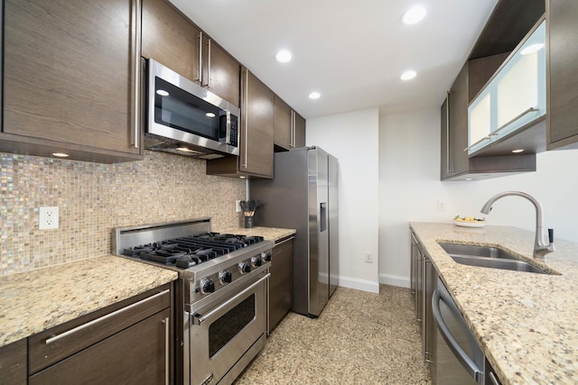 10 Regent St Unit 807, Jersey City, NJ 07302 - kitchen featuring appliances with stainless steel finishes, dark brown cabinetry, tasteful backsplash, light stone countertops, and recessed lighting