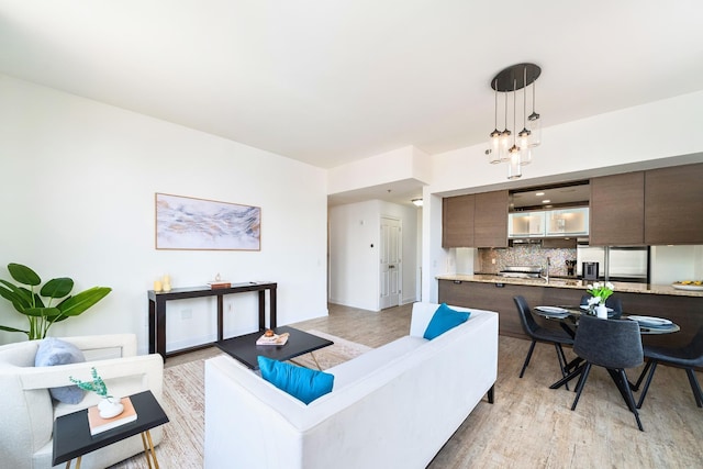 10 Regent St Unit 807, Jersey City, NJ 07302 - living area with light wood-style floors and a chandelier