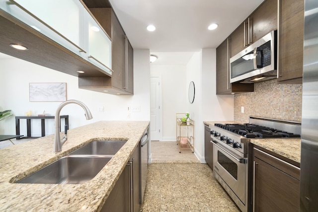 10 Regent St Unit 807, Jersey City, NJ 07302 - kitchen with stainless steel appliances, dark brown cabinets, tasteful backsplash, recessed lighting, and light stone countertops